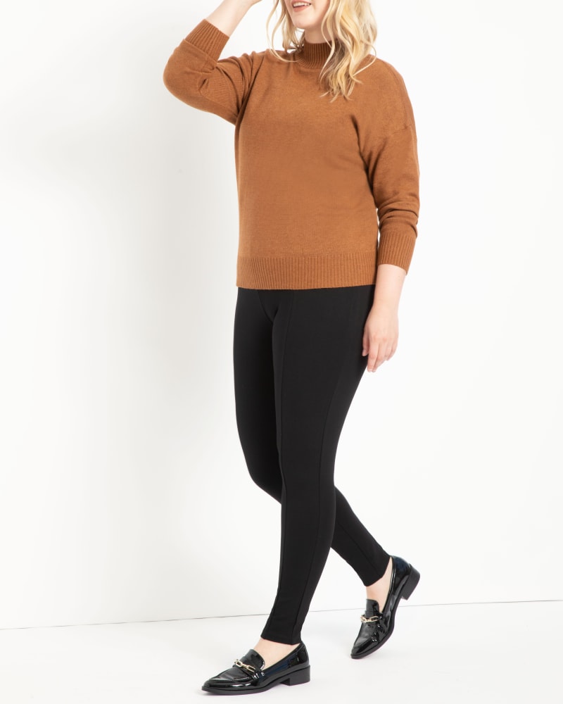 Front of a model wearing a size 14 Miracle Flawless Legging in Black by ELOQUII. | dia_product_style_image_id:290215